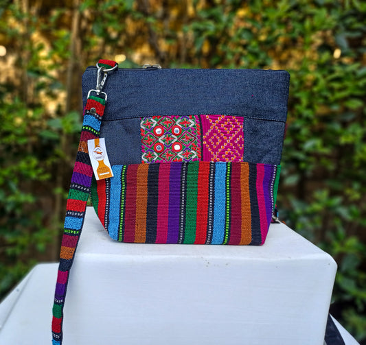 Fashionable cross body bag made with handwoven fabric and durable denim. Embellished with hand embroidery and mirror work. With an adjustable strap and waterproof lining. Perfect for carrying around your daily accessories.